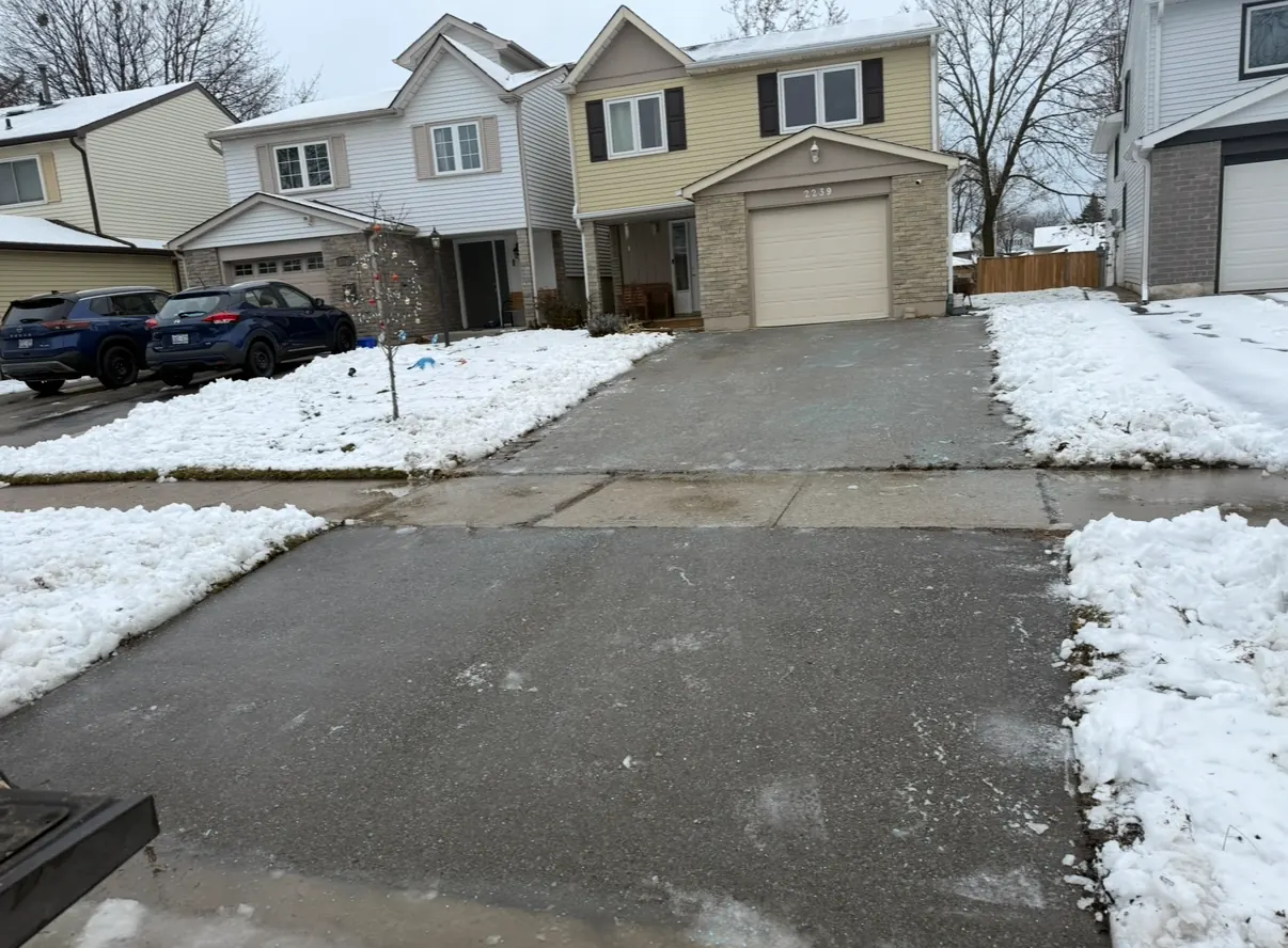 Driveway and sidewalk cleared down to pavement after a snowfall